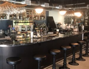 Marble-topped bar with hanging wine glasses